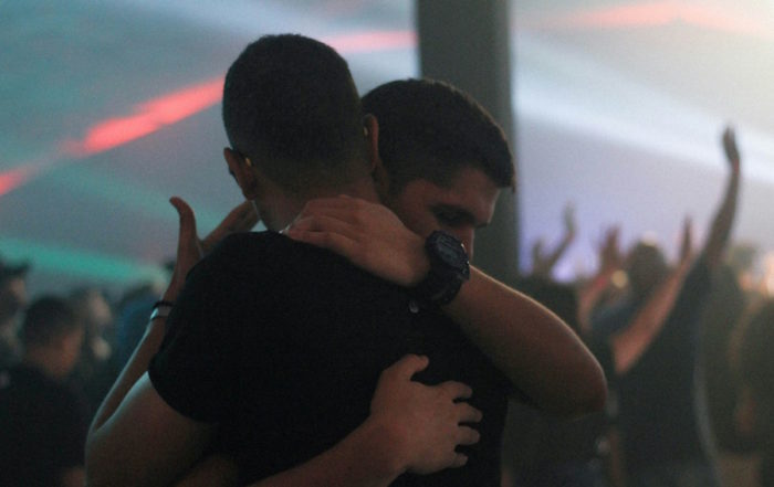 Innocent Love: Two men embracing in an emotional moment at an event.